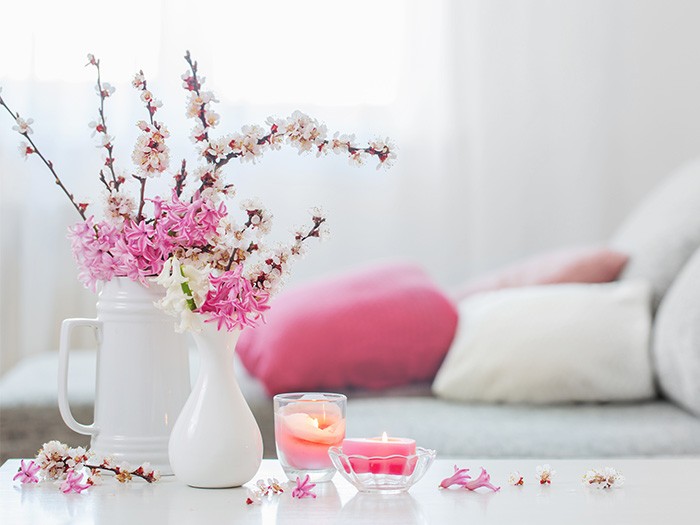 flower vase with pink flowers and pink candles burning
